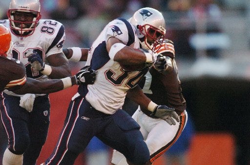 Cedric Cobbs carries for the Patriots in 2004.