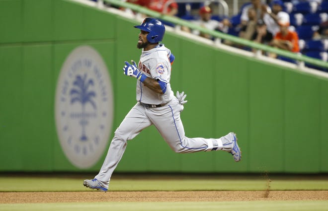 The Mets' Jose Reyes heads to second with a double during New York's 5-3 win over the Miami Marlins on Friday. Reyes had three hits in the game. Associated Press