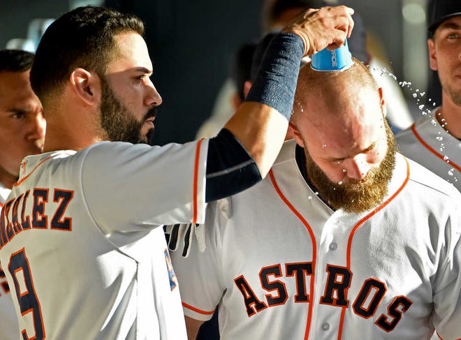 Houston's Evan Gattis, right, is doused by Marwin Gonzalez after hitting a three-run home run in the second inning on Saturday in Houston. Gattis added another homer later, leading the Astros to a 7-2 win over the Los Angeles Angels.