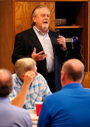 Capital Mortgage CEO Royce C. Lewis III talks to his employees during a lunch celebrating the company's 30th anniversary.