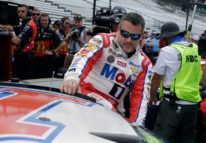 Sprint Cup Series driver Tony Stewart (14) climbs into his car before qualifications for the Brickyard 400 NASCAR auto race at Indianapolis Motor Speedway in Indianapolis, Saturday, July 23, 2016.