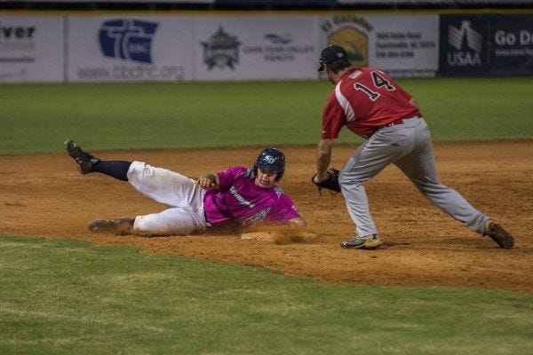 Fayetteville's Hunter Dolshun slides safely into third base with a triple against Petersburg. For more photos, go to fayobserver.com.