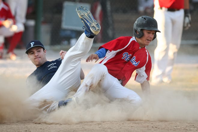Natick's Andrew Ciampa slides into home safely with Franklin pitcher Matt Dumart trying to make the play in a regular season game at Natick High last Thursday. Both teams are competing in the CMass Senior Babe Ruth playoffs this week. DAILY NEWS PHOTO/DAN HOLMES