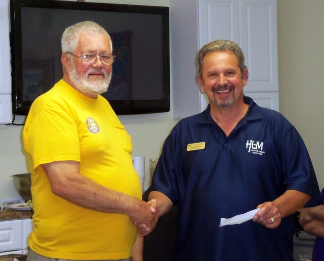 Ormond-by-the-Sea Lions President Les Walter, left, presented a $250 donation to Halifax Urban Ministries Director Mark Geallis.