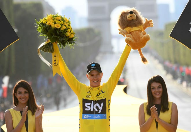 2016 race winner Britain???s Chris Froome, wearing the overall leader???s yellow jersey, celebrates on the podium after the twenty-first stage of the Tour de France cycling race in Paris, France, Sunday, July 24, 2016. (Stephane Mantey Pool via AP)