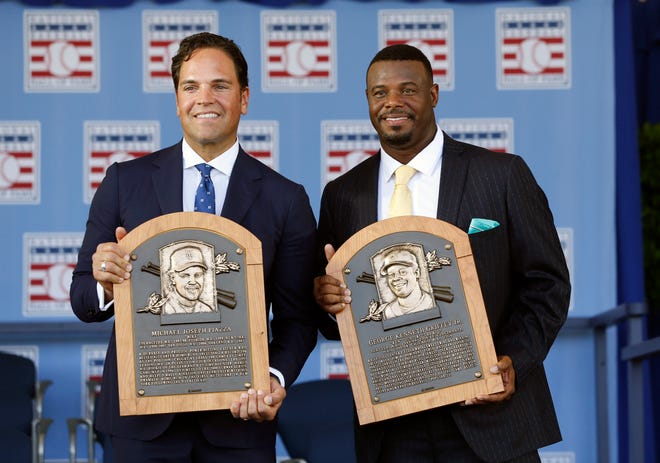 National Baseball Hall of Fame inductees Mike Piazza, left, and Ken Griffey Jr. hold their plaques after an induction ceremony at the Clark Sports Center on Sunday, July 24, 2016, in Cooperstown, N.Y.