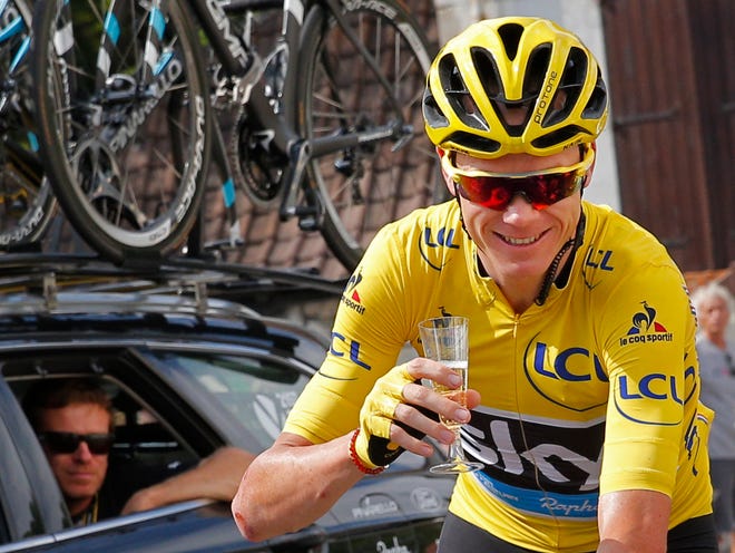 Britain's Chris Froome, wearing the overall leader's yellow jersey, celebrates with a glass of champagne during the twenty-first stage of the Tour de France cycling race over 113 kilometers (70.2 miles) with start in Chantilly and finish in Paris, France, Sunday, July 24, 2016. (AP Photo/Christophe Ena)