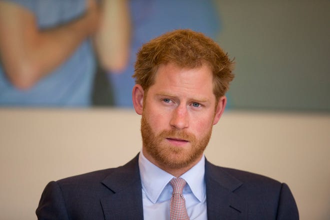 This is a Thursday, July 7, 2016 file photo of Britain's Prince Harry as he takes part in a round table discussion with HIV doctors at King's College Hospital in south London as part of his desire to learn more and raise public awareness in the fight against HIV and AIDS both internationally and in the UK. Britain's Prince Harry said in mid July 2016 that he wishes he had spoken sooner about the death of his mother, Princess Diana. Harry, who did not speak about his bereavement until three years ago, told the BBC that it wasn't a sign of weakness to speak about problems. (AP Photo/Matt Dunham, Pool, File)