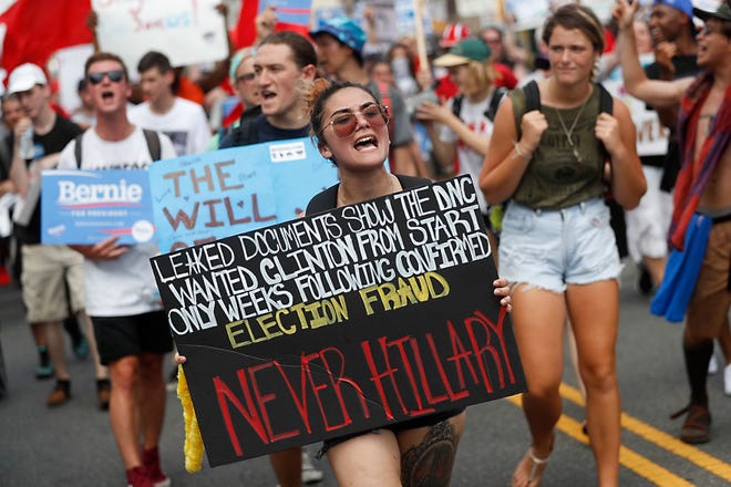 Supporters of Sen. Bernie Sanders, D-Vt., march during a protest in downtown Philadelphia, Monday, July 25, 2016, on the first day of the Democratic National Convention. On Sunday, Debbie Wasserman Schultz announced she would step down as DNC chairwoman at the end of the party's convention, after emails presumably stolen from the DNC by hackers were posted to the website Wikileaks. (AP Photo/John Minchillo)