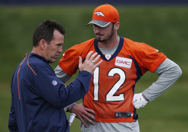 Denver head coach Gary Kubiak, left, confers with rookie quarterback Paxton Lynch during rookie camp practice May 6 in Englewood, Colorado. ASSOCIATED PRESS FILE/DAVID ZALUBOWSKI