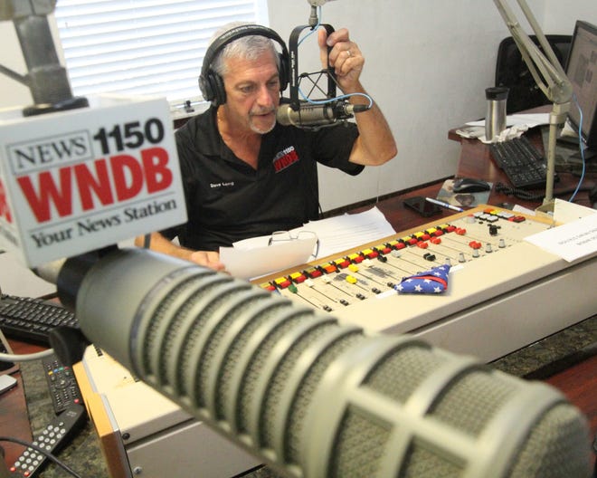 Dave Laing, host of the morning show at WNDB radio in Daytona Beach, reads during a recent broadcast.

News-Journal/David Tucker
