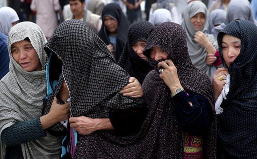 Afghan women mourn during the funeral of victims who died from a suicide attack, in Kabul, Afghanistan, Sunday, July 24, 2016. Afghanistan held a national day of mourning on Sunday, a day after a suicide bomber killed at least 80 people who were taking part in a peaceful demonstration in Kabul. The attack was claimed by the Islamic State group. (AP Photos/Massoud Hossaini)