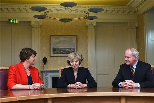 Britain's Prime Minister Theresa May, centre, poses for a photo with Northern Ireland's First Minister Arlene Foster, left and Deputy First Minister Martin McGuinness, prior to their meeting, Stormont Castle in Belfast, Northern Ireland, Monday July 25, 2016. May met Northern Ireland"™s leaders in Belfast Monday in a bid to allay Northern Irish concerns about Britain's vote to leave the European Union. (Charles McQuillan/PA via AP)