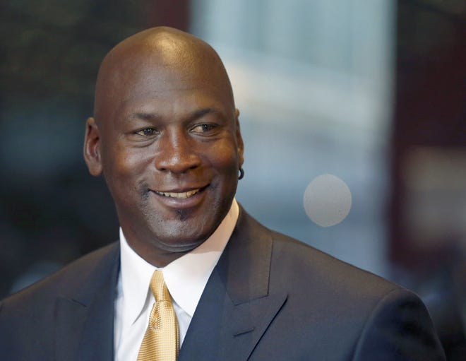 FILE - In this Aug. 21, 2015, file photo, former NBA star and current owner of the Charlotte Hornets, Michael Jordan, smiles at reporters in Chicago. Jordan announced Monday, July 25, 2016, heþÄôs giving $1 million to the Institute for Community-Police Relations and $1 million to the NAACP Legal Defense Fund to help build trust between blacks and law enforcement following several disturbing clashes around the country. AP PHOTO/CHARLES REX ARBOGAST