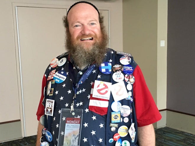 Jason Bloomberg's colorful ensemble was a testament to the unity that party leaders have been urging since the start of the convention. The Wyoming delegate for Clinton traveled 84 hours to get to the City of Brotherly Love, and he made the near cross-country trip with a Sanders supporter. His buttons urge Democrats to be "Trump Busters."
