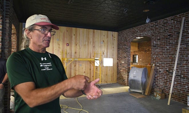 Shakespeare’s Pizza Manager Kurt Mirtsching describes cleaning the 22,000 bricks that were salvaged from the restaurant’s original building at 225 S. Ninth St. during a tour Monday of the new building housing Shakespeare’s. Mirtsching said he hopes to have the restaurant open by mid-August
