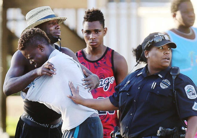 People embrace after a fatal shooting at Club Blu in Fort Myers, Florida, on Monday.