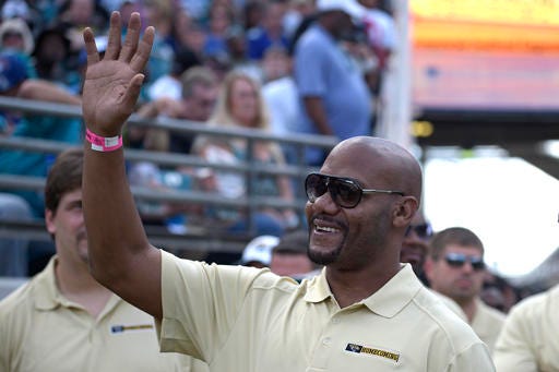 FILe - In this Nov. 30, 2014, file photo, former Jacksonville Jaguars receiver Jimmy Smith waves to fans from the sideline during the first half of an NFL football game against the New York Giants in Jacksonville, Fla. Retired receiver Jimmy Smith, whose drug addiction often overshadowed his five consecutive Pro Bowls, will be the next member of Jacksonville's ring of honor. The team announced Tuesday, July 26, 2016, that Smith will be inducted into the "Pride of the Jaguars" on Dec. 11 during halftime of its home game against Minnesota. (AP Photo/Phelan M. Ebenhack, File)