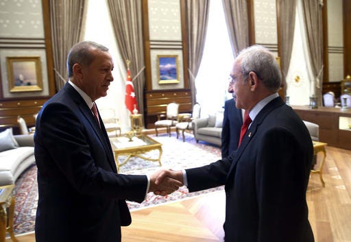 Turkey's President Recep Tayyip Erdoganl left, greets Kemal Kilicdaroglu before a meeting n Ankara, Turkey, Monday, July 25, 2016. Erdogan met Monday with leaders of the main opposition parties, Republican People's Party leader Kemal Kilicdaroglu, National Movement Party leader Devlet Bahceli and Turkish Prime Minister Binali Yildirim. The meeting took place amid a government crackdown upon people suspected of links with Fethullah Gulen, a self-exiled cleric that Erdogan blames for the failed coup attempt.(Presidential Press Service, Kayhan Ozer/Pool Photo via AP)