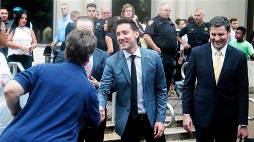 David Daleiden, center, speaks with supporters outside the Harris County Criminal Justice Center, Tuesday, July 26, 2016, in Houston. A Texas judge on Tuesday dismissed the last remaining charge against, David Daleiden and Sandra Merritt, two California anti-abortion activists who made undercover videos of themselves trying to buy fetal tissue from Planned Parenthood. (James Nielsen/Houston Chronicle via AP)
