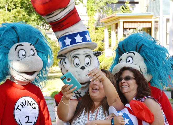 A character portraying the Cat in the Hat poses for a selfie with supporters Tuesday, July 26, 2016, after he announced he is running for President with running mates Thing 1 and Thing 2 outside the childhood home of their creator Theodor Geisel, better known as Dr. Seuss, on Fairfield Street in Springfield, Mass. The event served as the official launch for the new Random House book "One Vote, Two Votes, I Vote, You Vote."