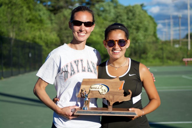 Wayland girls tennis coach Erin Reeves (left) and tri-captain Allie Kunen smile while holding the championship trophy after defeating rival Concord-Carlisle in the Division 2 North final last month. COURTESY PHOTO