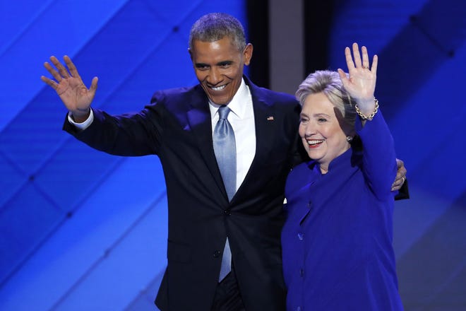 President Barack Obama and Democratic presidential nominee Hillary Clinton wave to delegates on Wednesday, July 27, 2016, after Obama's speech during the third day of the Democratic National Convention in Philadelphia.