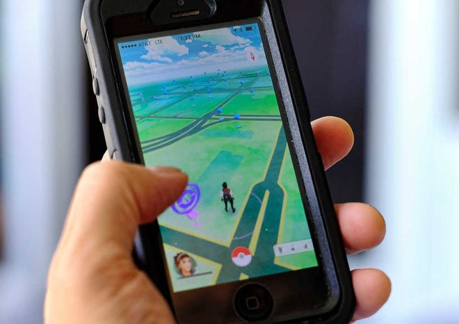 FILE - In this Friday, July 8, 2016, file photo, "Pokemon Go" is displayed on a cell phone in Los Angeles. Pokemon Goâ€™s origins are as peculiar as any of the creatures inhabiting the game. (AP Photo/Richard Vogel, File)-AP