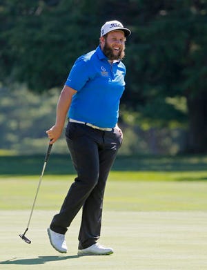 Andrew Johnston, of England, smiles after a putt on the 11th hole during a practice round for the PGA Championship golf tournament at Baltusrol Golf Club in Springfield, N.J., Tuesday, July 26, 2016. (AP Photo/Tony Gutierrez)