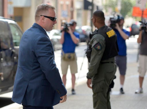 Officer Garrett Miller, one of the six members of the Baltimore Police Department charged in connection to the death of Freddie Gray, arrives at a courthouse for his pre-trial proceedings in Baltimore, Wednesday, July 27, 2016. (AP Photo/Steve Ruark)