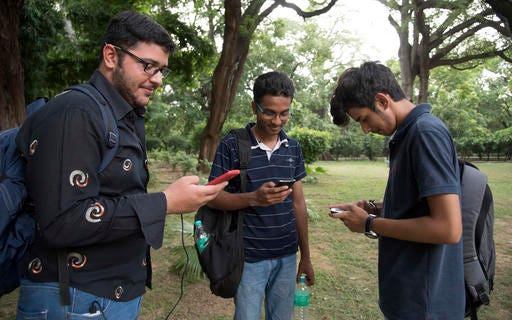 In this Friday, July 22, 2016 photo, Pokemon Go players meet in Lodhi Garden in New Delhi, India. "Pokemon Go," the highly addictive online game, has landed in India and thousands are out searching for pokemon characters as the mania spreads. Although it has not been launched officially in India, the augmented-reality-based game has caught on, with fans also using virtual private networks (VPNs) to change their locations and catch pokemons in New York and London while sitting in their Indian homes. (AP Photo/Thomas Cytrynowicz)