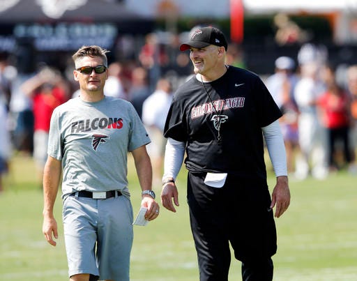FILE - In this July 31, 2015, file photo, Atlanta Falcons head coach Dan Quinn, right, talks with general manager Thomas Dimitroff during an NFL football training camp in Flowery Branch, Ga. The Falcons were 8-8 in Quinn's first season. (AP Photo/John Bazemore, File)