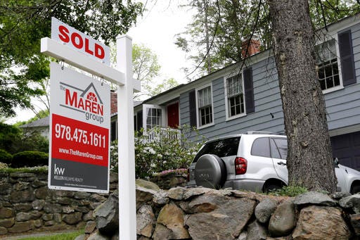 FILE - This Tuesday, May 24, 2016, file photo shows a "Sold" sign in front of a house in Andover, Mass. On Wednesday, July 27, the National Association of Realtors releases its June report on pending home sales, which are seen as a barometer of future purchases. (AP Photo/Elise Amendola, File)