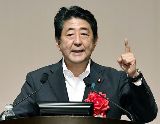 Japanese Prime Minister Shinzo Abe delivers a speech in Fukuoka, southern Japan, Wednesday, July 27, 2016. Prime Minister Abe announced plans Wednesday for a fresh barrage of economic stimulus to help revive stalling growth. Abe put the scale of the extra spending at more than 28 trillion yen ($265 billion), the Kyodo News Service and other local media reported. (Iori Sagisawa/Kyodo News via AP)