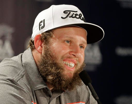 Andrew Johnston, of England, smiles as he answers a question before a practice round for the PGA Championship golf tournament at Baltusrol Golf Club in Springfield, N.J., Wednesday, July 27, 2016. (AP Photo/Chuck Burton)
