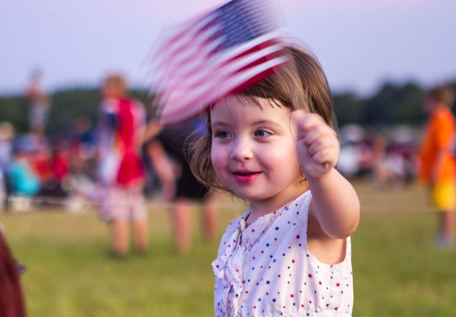 A child waves an American flag at the 47th Annual God and Country Day, an Ocala Jaycees-sponsored event, in Ocala on July 4, 2016. (Alan Youngblood / Star-Banner)