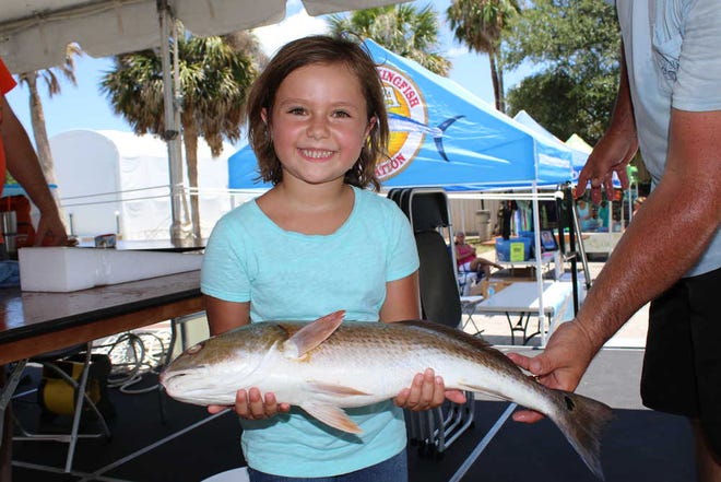 CHRISTINE RODENBAUGH/ Kaylee Brown, a second-grader at Palencia Elementary, caught this 5.75-pound redfish on July 8 in the Junior Challenge tournament at Camachee Cove Yacht Harbor.