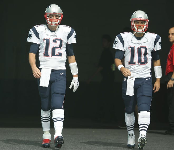 Patriots quarterbacks Tom Brady, left, and Jimmy Garoppolo enter the field in January. The Patriots will open camp July 27 knowing the cornerstone of their franchise wonít be available for the first quarter of the season, but it will allow them to use the unfavorable outcome to get a meaningful evaluation of Brady understudy Jimmy Garoppolo. AP FILE PHOTO