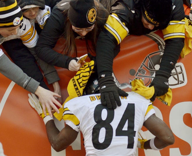 Fans reach to touch Antonio Brown (84) after the Pittsburgh Steelers 28-12 win over the Cleveland Browns on Jan. 3 in Cleveland. Brown, who had 136 receptions in 2015 for 1,834 yards is the 12th highest-payed player in the NFL and hasn't had a full renegotiation of his salary since 2012. His deal expires in 2017.
