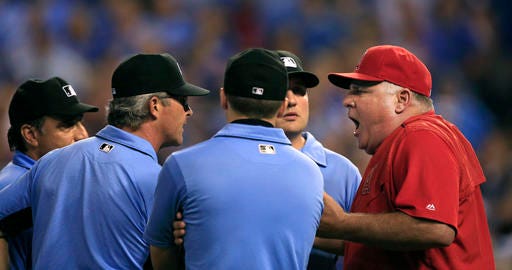 Los Angeles Angels manager Mike Scioscia, right, argues with umpires during the seventh inning of a baseball game against the Kansas City Royals at Kauffman Stadium in Kansas City, Mo., Wednesday, July 27, 2016. The Angels played the game under protest. The Royals won 7-5. (AP Photo/Orlin Wagner)