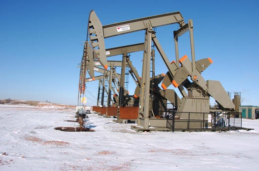 This Feb. 26, 2015 photo, shows an oil well on the Fort Berthold Indian Reservation near Mandaree, North Dakota. U.S. officials announced plans Thursday, July 28, 2016, to speed up permitting for oil and gas drilling on federal and American Indian lands to reduce delays, as applications were projected to be down amid an ongoing price slump. (AP Photo/Matthew Brown)
