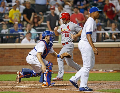 St. Louis Cardinals' Randal Grichuk (15) scores during the ninth inning of a baseball game, Wednesday, July 27, 2016, in New York. New York Mets catcher Travis d'Arnaud (18) waits for the throw, which was too late, as relief pitcher Jeurys Familia, right, heads back to the mound. The Cardinals won 5-4. (AP Photo/Kathy Willens)