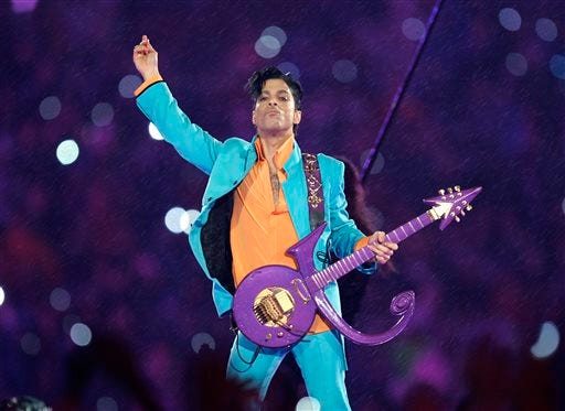 FILE - In this Feb. 4, 2007 file photo, Prince performs during the halftime show at the Super Bowl XLI football game at Dolphin Stadium in Miami. Prince’s family says an official tribute concert honoring the late icon will take place on October 13, at the U.S. Bank Stadium in Minneapolis. (AP Photo/Chris O'Meara, File)