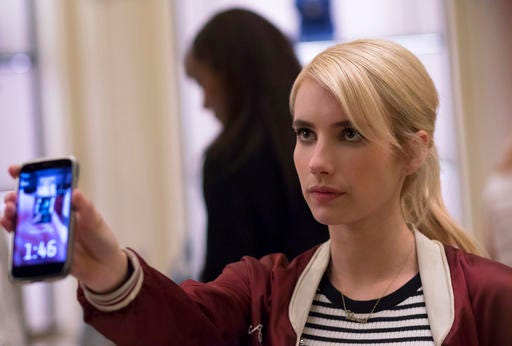 This image released by Lionsgate shows Emma Roberts in a scene from the thriller, "Nerve." Nerve is an app-based game that’s all the rage among the kids. You can choose to be a “player” or a “watcher.” Players are given dares by anonymous masses of watchers with the promise of cash prizes at the end of each dare, which they have to film themselves doing. (Niko Tavernise/Lionsgate via AP)
