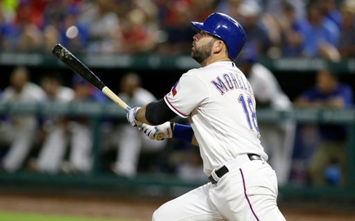 Texas Rangers' Mitch Moreland watches his solo home run during the eighth inning of a baseball game against the Kansas City Royals in Arlington, Texas, Thursday, July 28, 2016. (AP Photo/LM Otero)