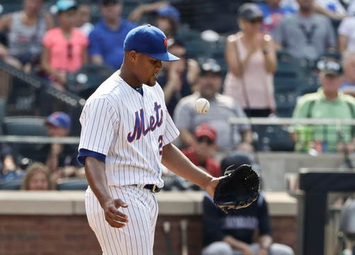 New York Mets relief pitcher Jeurys Familia reacts after a run scored on a wild pitch during the ninth inning of a baseball game against the Colorado Rockies Thursday, July 28, 2016, in New York. (AP Photo/Frank Franklin II)