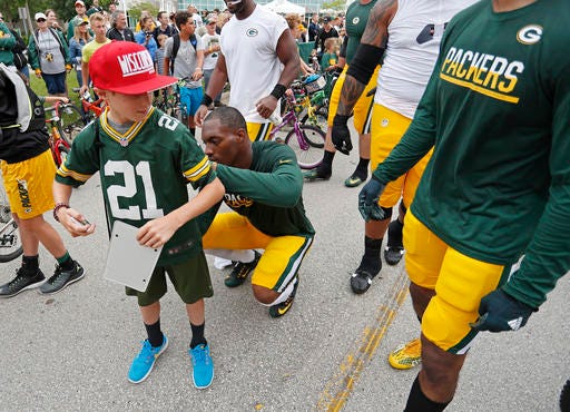 Green Bay Packers free safety Ha Ha Clinton-Dix signs a fans jersey during NFL football training camp, Thursday, July 28, 2016, in Green Bay, Wis. (AP Photo/Matt Ludtke)