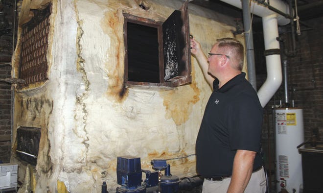 Dan Root, transportation/facilities supervisor for Sturgis Public Schools, takes a look at the boiler from 1952 inside Congress Elementary School. If voters approve a sinking fund request for the district Aug. 2, replacement of the boiler is among projects the district hopes to take on in the first five years.
