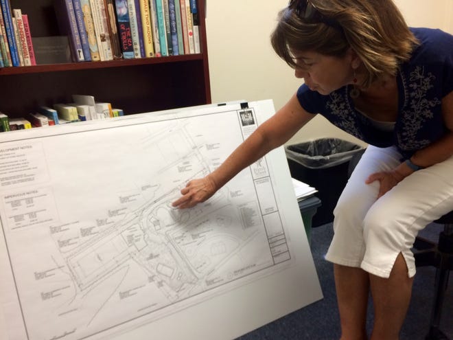 Brenda Esch, head of school at the Friends School of Wilmington, explains plans for a campus redesign in her office Thursday. City planners are reviewing a proposal to add five buildings and a driveway to the Peiffer Avenue facility. CAMMIE BELLAMY/STARNEWS