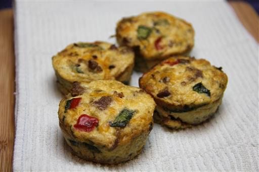 This May 2016 photo shows bake-ahead morning egg cups in Coronado, Calif. This dish is from a recipe by Melissa d'Arabian. (Melissa d'Arabian via AP)